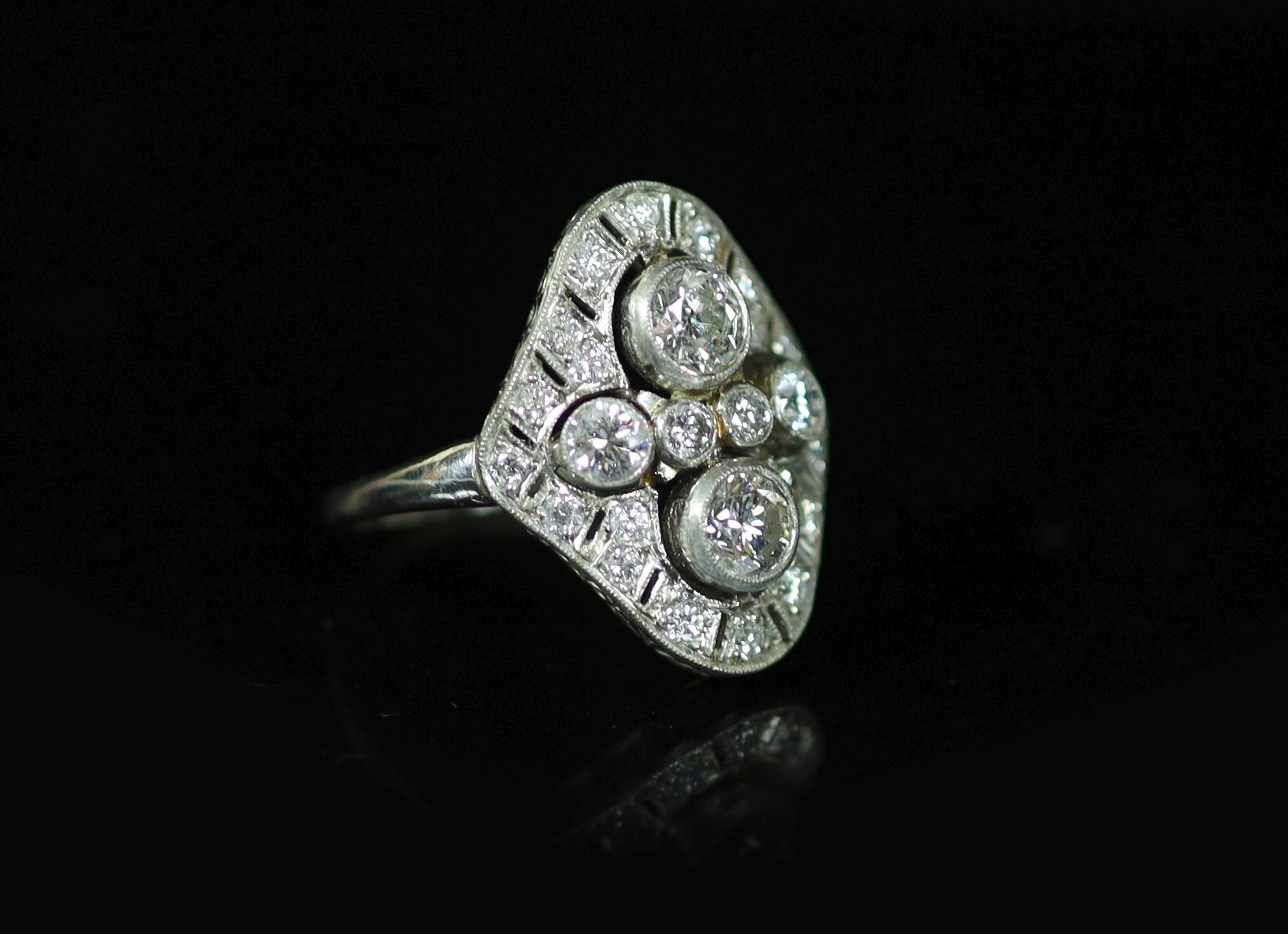 A 1930's/1940's platinum and millegrain set diamond cluster dress ring